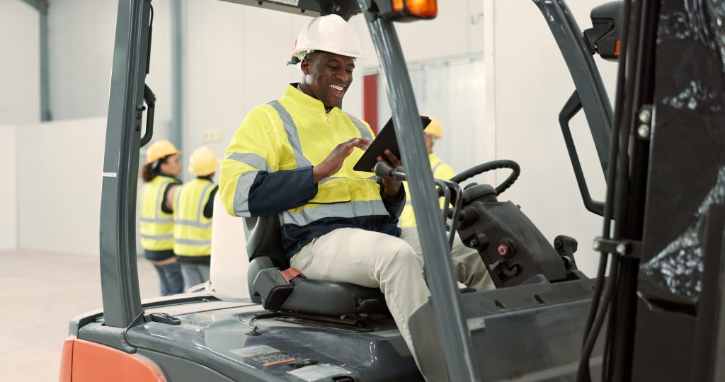 Man using a tablet with custom software on a forklift